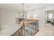 Upstairs landing featuring wood and wrought iron banister, and decorative lighting at 6831 Conservatory Ln, Charlotte, NC 28210