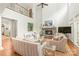 Spacious living room with soaring ceilings, stone fireplace, neutral decor, and an abundance of natural light at 6831 Conservatory Ln, Charlotte, NC 28210