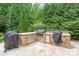 Outdoor kitchen with stainless steel appliances, stone countertops, and built-in cabinetry for storage at 6831 Conservatory Ln, Charlotte, NC 28210