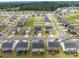Expansive aerial view of a residential neighborhood with well-maintained homes and tree-lined streets at 703 Pointe Andrews Dr, Concord, NC 28025