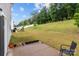 Spacious backyard featuring a patio, grassy area, and a play structure for outdoor enjoyment at 703 Pointe Andrews Dr, Concord, NC 28025