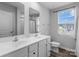 Bathroom featuring dual sinks, large mirror and natural light coming through the window at 703 Pointe Andrews Dr, Concord, NC 28025