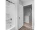 Clean and bright bathroom featuring a tub with a shower and a view to the next floor at 703 Pointe Andrews Dr, Concord, NC 28025