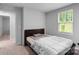 Cozy bedroom featuring a bed, window, and doorway, offering a comfortable living space at 703 Pointe Andrews Dr, Concord, NC 28025