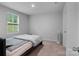 Simple bedroom with a bed, window overlooking a yard, and neutral carpet at 703 Pointe Andrews Dr, Concord, NC 28025