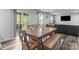 Bright dining area with wood table, bench seating, and sliding glass doors to the backyard at 703 Pointe Andrews Dr, Concord, NC 28025
