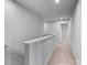 Upstairs hallway featuring neutral carpet and walls at 703 Pointe Andrews Dr, Concord, NC 28025