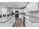 Modern kitchen with stainless steel appliances, granite countertops, and white cabinets at 703 Pointe Andrews Dr, Concord, NC 28025