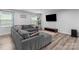 Comfortable living room showcasing a plush sectional sofa, large-screen TV, and modern decor accents at 703 Pointe Andrews Dr, Concord, NC 28025