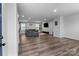 Bright and airy living room featuring sleek laminate flooring, recessed lighting, and an open floor plan at 703 Pointe Andrews Dr, Concord, NC 28025
