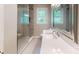 Bathroom featuring a glass shower door, window, and vanity with sink at 7101 City View Dr, Charlotte, NC 28212
