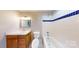Bathroom featuring a vanity, toilet, and shower-tub combo with blue tile accents at 7101 City View Dr, Charlotte, NC 28212