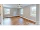 Bright bedroom featuring hardwood floors, neutral colors, and double windows for natural light at 7101 City View Dr, Charlotte, NC 28212
