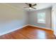 Bedroom featuring hardwood floors, natural light, and a ceiling fan for comfort at 7101 City View Dr, Charlotte, NC 28212