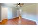Comfortable bedroom with hardwood floors, closet space, and neutral wall color at 7101 City View Dr, Charlotte, NC 28212