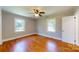 Bedroom with two windows, hardwood floors and a ceiling fan at 7101 City View Dr, Charlotte, NC 28212