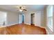 Bedroom featuring hardwood floors, closet, ceiling fan and a view to an adjacent room at 7101 City View Dr, Charlotte, NC 28212