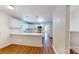 Well-lit kitchen featuring white cabinets, an eat-in island, stainless steel appliances, and modern pendant lighting at 7101 City View Dr, Charlotte, NC 28212
