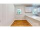 Bright and airy kitchen boasts white cabinets, stylish subway tile backsplash, and wood-look floors at 7101 City View Dr, Charlotte, NC 28212