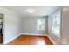 Cozy living space featuring hardwood floors, neutral paint, and great natural light through multiple windows at 7101 City View Dr, Charlotte, NC 28212