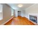 Inviting living room with hardwood floors, a classic fireplace, and a view into other living spaces at 7101 City View Dr, Charlotte, NC 28212