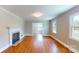 Bright living room showcasing hardwood floors, a fireplace, and abundant natural light from large windows at 7101 City View Dr, Charlotte, NC 28212