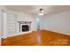 Light-filled living room featuring a fireplace, white trim, and neutral walls at 7101 City View Dr, Charlotte, NC 28212
