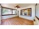 Bright sunroom featuring large windows, ceiling fan, and an inviting atmosphere at 7101 City View Dr, Charlotte, NC 28212