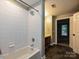 Well-lit bathroom with a walk-in shower, tiled floor, and modern finishes at 718 W Trade St, Charlotte, NC 28202