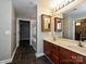 Modern bathroom featuring double sinks, a large mirror, and tiled floors and walk-in shower at 718 W Trade St, Charlotte, NC 28202