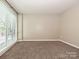 Carpeted bedroom with natural light streaming through large windows and neutral walls at 718 W Trade St, Charlotte, NC 28202