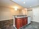 Open kitchenette features modern appliances, brown cabinets, and stylish tiled floors at 718 W Trade St, Charlotte, NC 28202