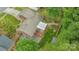 Aerial view shows the home's backyard with mature trees, deck, patio, and fenced yard at 7312 Barcliff Dr, Charlotte, NC 28212