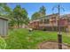 Spacious backyard featuring a deck, lush lawn, and mature trees, perfect for outdoor activities at 7312 Barcliff Dr, Charlotte, NC 28212