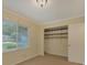 Bright bedroom featuring a window with blinds and a closet with shelving at 7312 Barcliff Dr, Charlotte, NC 28212