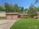 Charming single-story home featuring a two-car garage and a well-manicured lawn, exuding curb appeal at 7312 Barcliff Dr, Charlotte, NC 28212