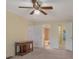 Spacious main bedroom with ceiling fan, console table, and multiple doorways to bathroom and hallway at 7312 Barcliff Dr, Charlotte, NC 28212