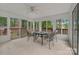 Bright sunroom with tiled floors, surrounded by large windows offering views of the backyard at 7312 Barcliff Dr, Charlotte, NC 28212