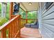 Relaxing back porch with a woven outdoor rug, comfortable seating, and a view of the lush surroundings at 8024 Eagle St, Mount Pleasant, NC 28124