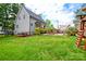 Spacious backyard with lush lawn, deck, hot tub, patio, and swing set at 8024 Eagle St, Mount Pleasant, NC 28124