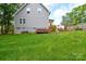 Wide backyard with a grass yard, wooden deck, and playset at 8024 Eagle St, Mount Pleasant, NC 28124