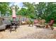 Spacious backyard with gravel area featuring a swing set, outdoor seating and dining, and playful atmosphere at 8024 Eagle St, Mount Pleasant, NC 28124