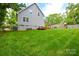 Great backyard featuring spacious grass, playground, and wooden deck with comfortable seating at 8024 Eagle St, Mount Pleasant, NC 28124