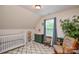 Bright Bedroom with natural light, patterned rug, crib, and rocking chair at 8024 Eagle St, Mount Pleasant, NC 28124