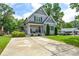 Two-story home with gray siding, mature trees, a spacious driveway, and a well-maintained lawn at 8024 Eagle St, Mount Pleasant, NC 28124