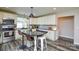 Bright eat-in kitchen features white cabinets, stainless appliances, granite counters, and a dark island with seating at 8024 Eagle St, Mount Pleasant, NC 28124