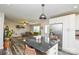 Kitchen island with granite countertops and seating looking into the living room at 8024 Eagle St, Mount Pleasant, NC 28124