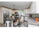 Eat-in kitchen features white cabinets, stainless appliances, gray counters, and island with seating at 8024 Eagle St, Mount Pleasant, NC 28124