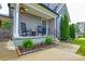 Inviting front porch with rocking chairs and stylish landscaping at 8024 Eagle St, Mount Pleasant, NC 28124