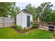 Backyard shed offers additional storage space with garden, swingset, and seating area nearby at 8024 Eagle St, Mount Pleasant, NC 28124